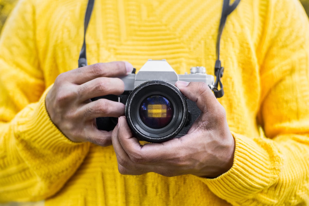 man holding a analog camera. photography vintage concept.